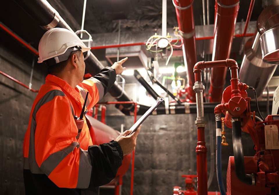 afff-transition-faqs Image: Battelle engineer examining an AFFF fire protection system on site