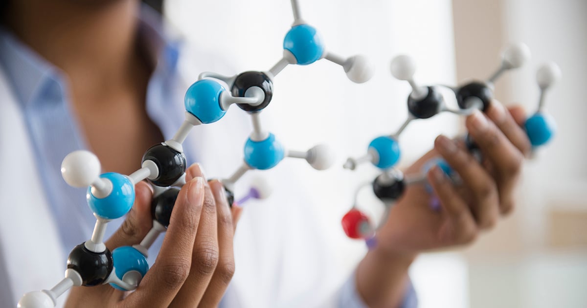 Photo: Woman holding 3d molecule structure