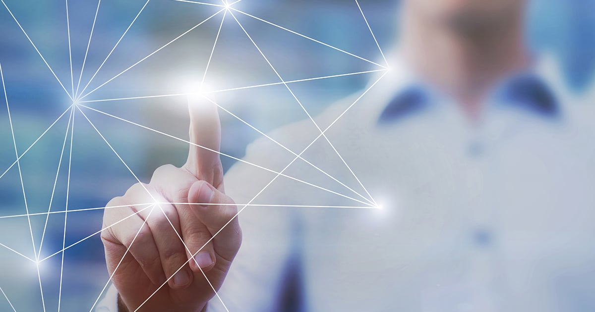 Photo: Pointer finger tapping a lit up point in 3d polygonal shape