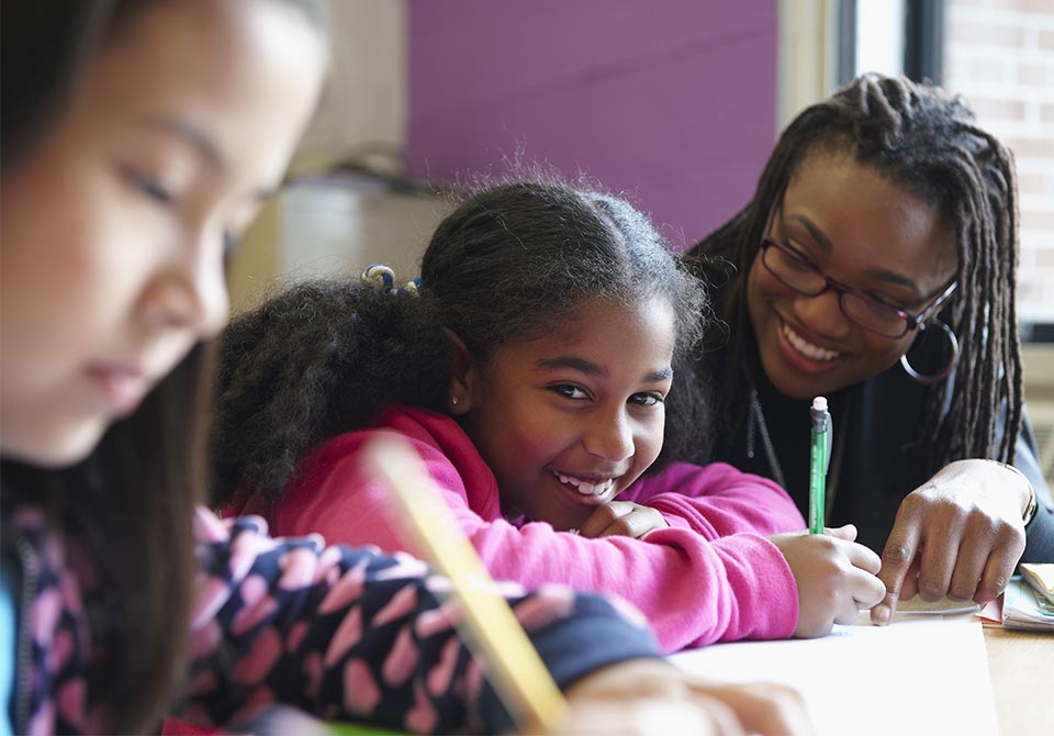 Photo: A girl working with her STEM teacher in the classroom