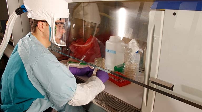 Photo: scientist examining samples at  the battelle biomedical research center