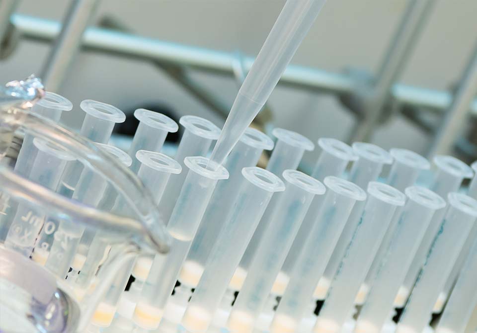 Photo: water being put in beakers in a lab