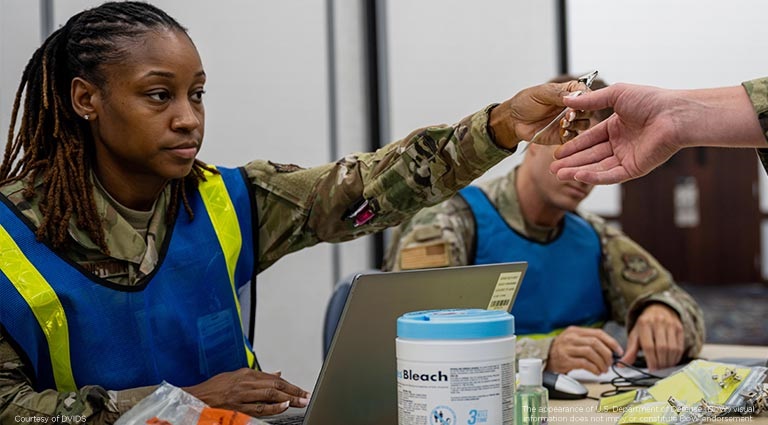alt=a military professional providing medical information to another warfighter
