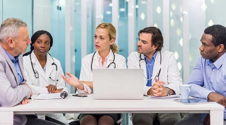 Photo: a group of public health professionals discussing data