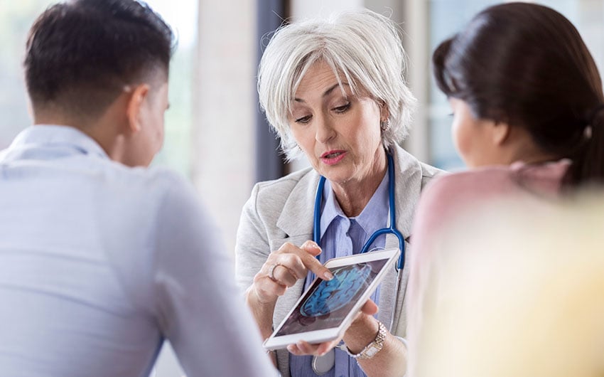 Photo: Physician consulting with patients