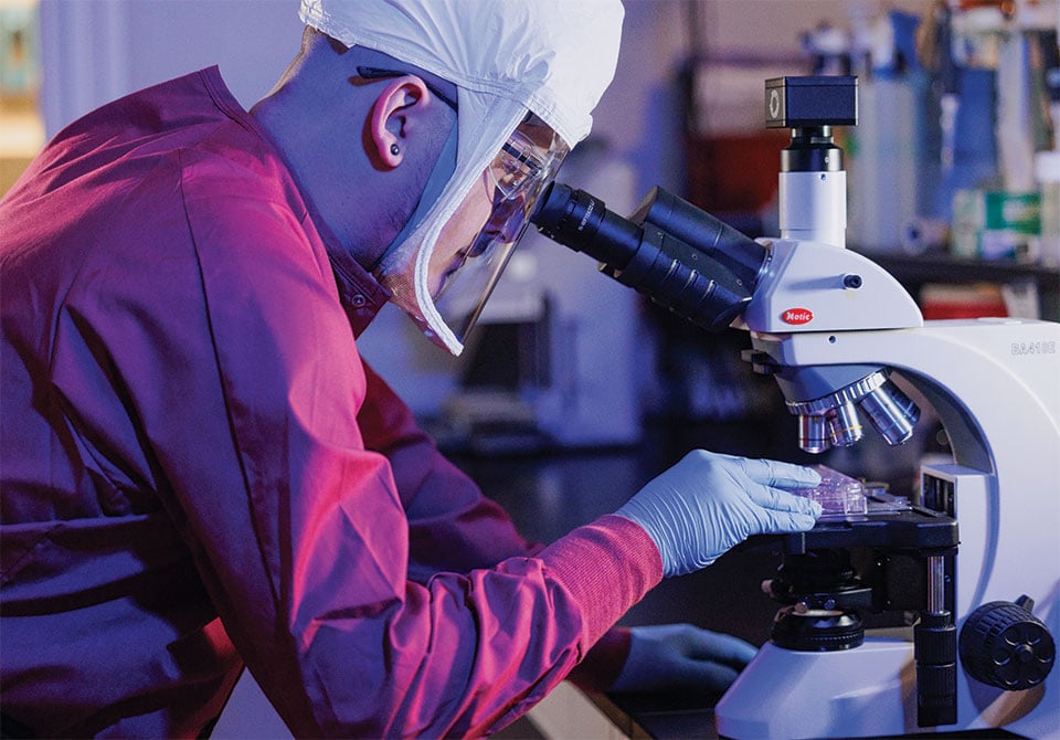 facilities-slider-bsl-2 Image: Battelle biologist examining a virus in a BSL-2 facility