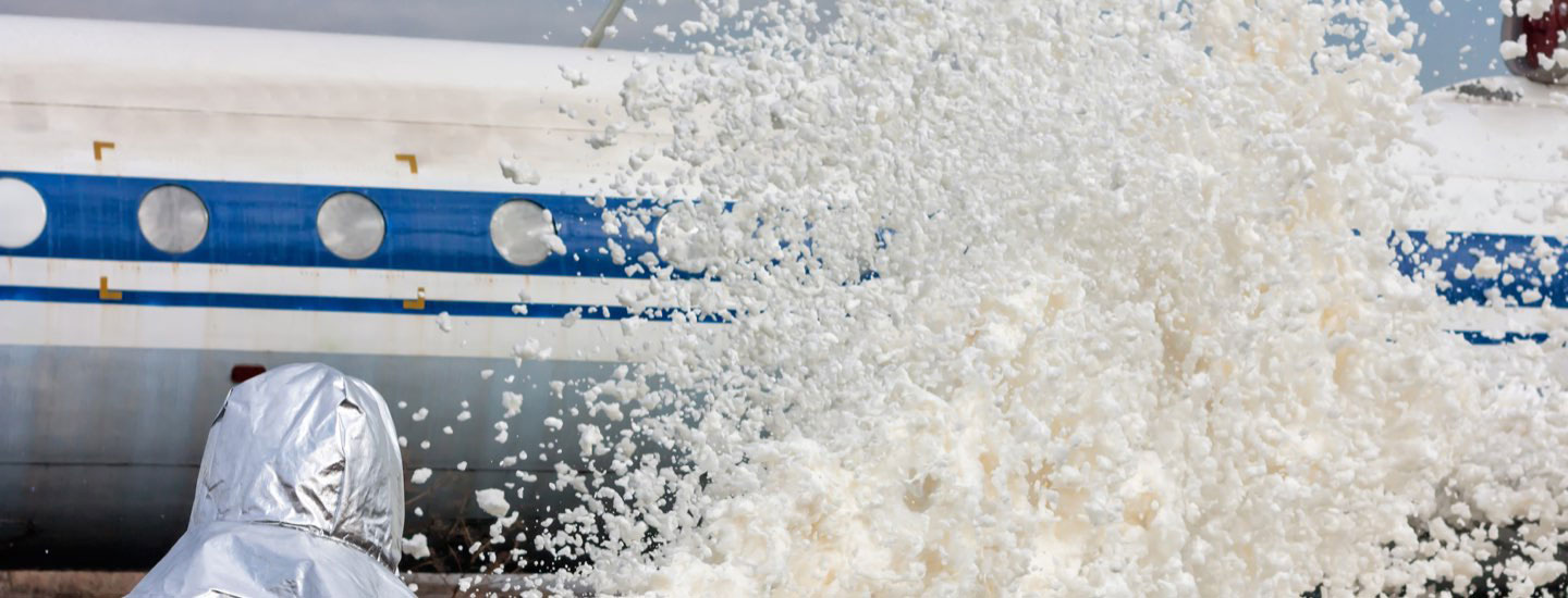 Photo: Firefighter spraying AFFF on a plane