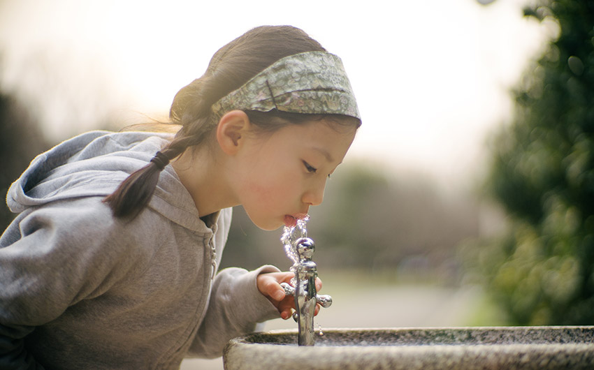 Photo: Child drinking water that may have negative PFAS health effects