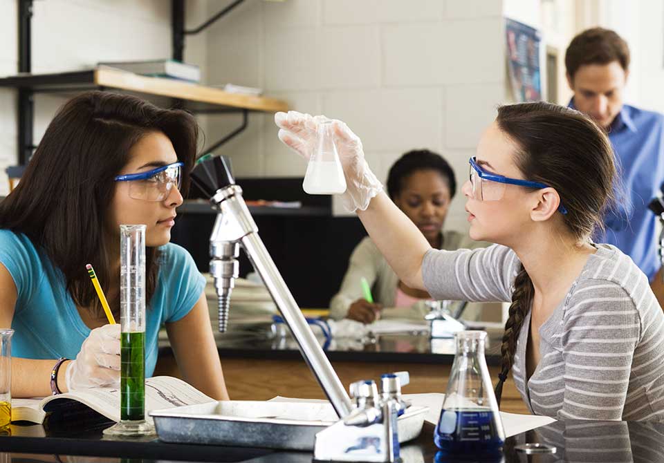 Photo: two STEM students working on a chemistry project