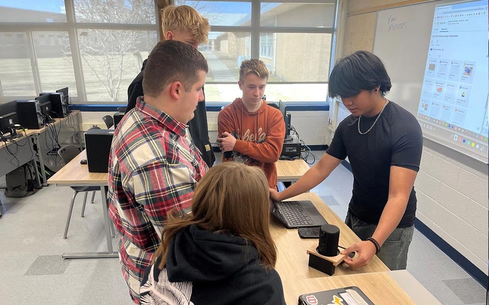 alt=teacher in a classroom teaching students