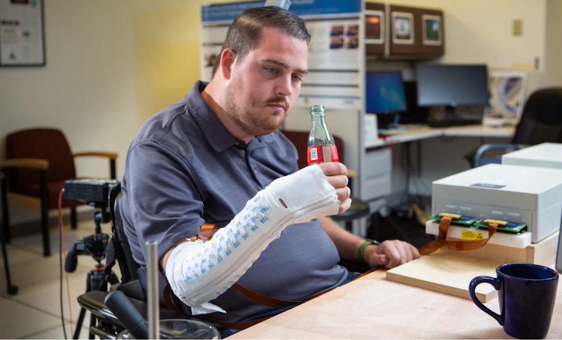 Advancing the Field of Neurotechnology at Battelle Photo: Ian Burkhart using the Battelle neurolife sleeve