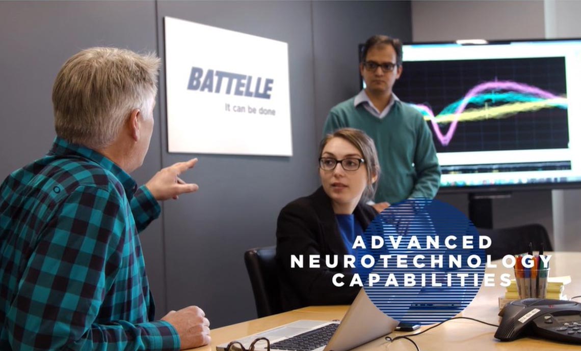 Neurotechnology Capabilities at Battelle Photo: 3 engineers in a meeting room discussing neuro data