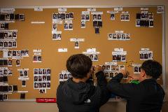 Photo: Students add their photos to the Toolik Community photo wall.  