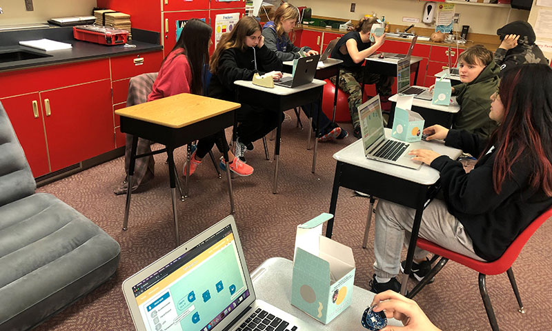 Photo: Students using computers inside a classroom