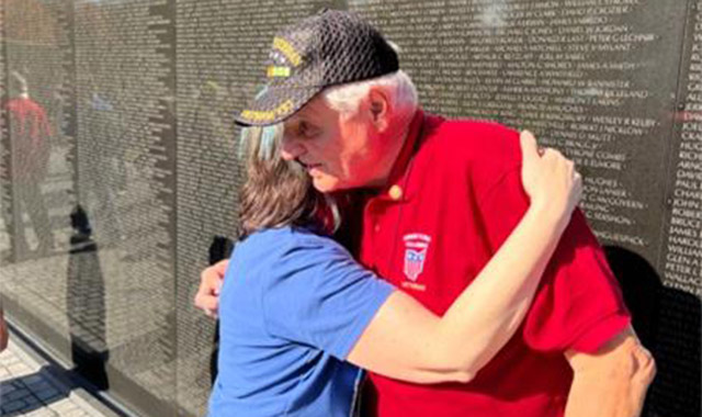 Photo: battelle guardian hugging a veteran