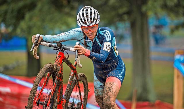 Battelle solver jen malik riding her bike through mud in the 2018 Collegiate Club Cyclocross National Championship 