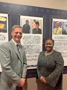 Photo: Patt Rawls, Battelle Program Manager, and Battelle CEO Lou Von Thaer standing at Patt’s display in the NVMM Impact Gallery